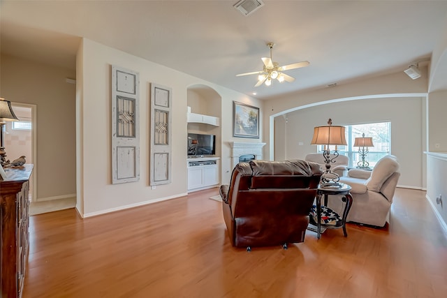 living room featuring ceiling fan and light hardwood / wood-style floors