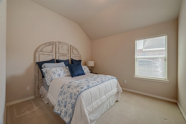 bedroom featuring light carpet and lofted ceiling