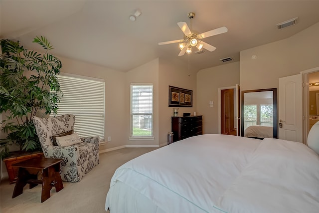 bedroom featuring light colored carpet, vaulted ceiling, and ceiling fan