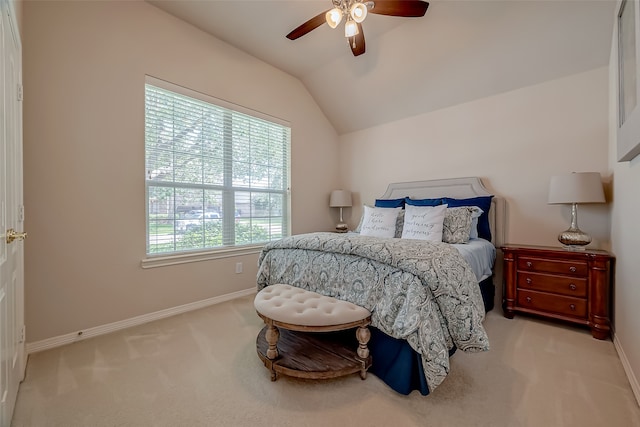 bedroom with ceiling fan, light colored carpet, and vaulted ceiling