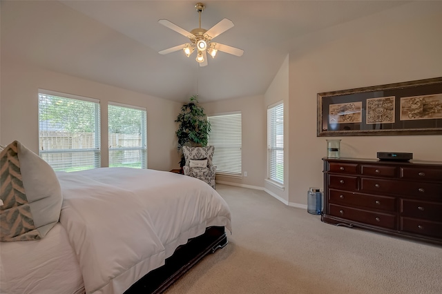 bedroom with ceiling fan, light colored carpet, and vaulted ceiling