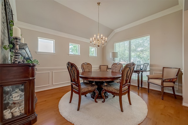 dining area with an inviting chandelier, light hardwood / wood-style flooring, a wealth of natural light, and crown molding