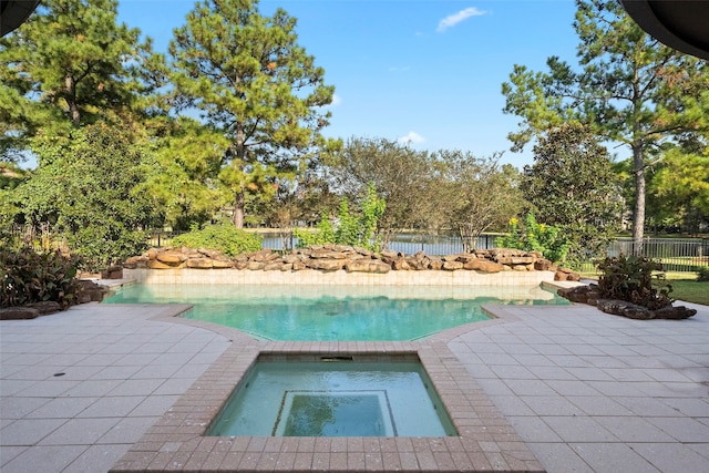 view of pool featuring a patio and an in ground hot tub