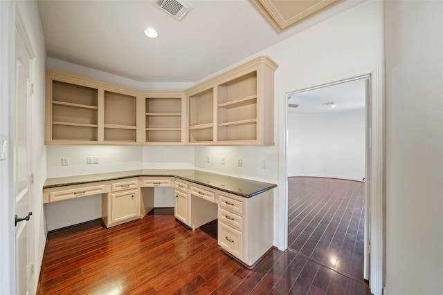 unfurnished office with built in desk and dark wood-type flooring