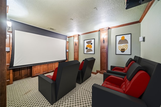 home theater with a textured ceiling, crown molding, decorative columns, and light colored carpet