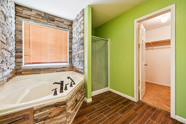 bathroom with plus walk in shower and hardwood / wood-style flooring