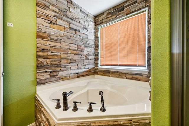 bathroom featuring tiled tub