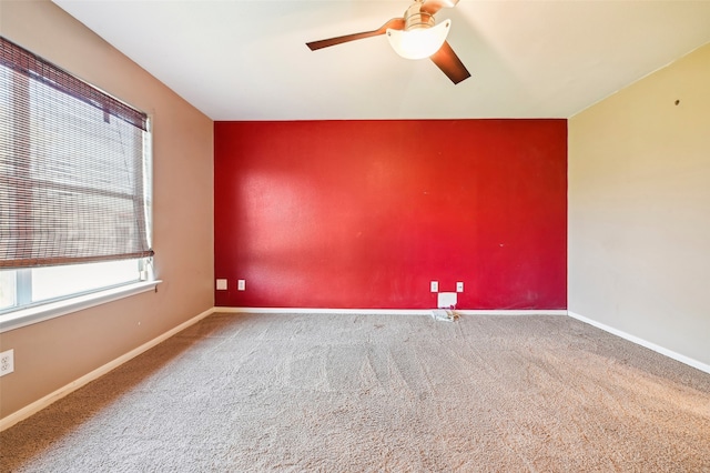 empty room with ceiling fan and carpet floors