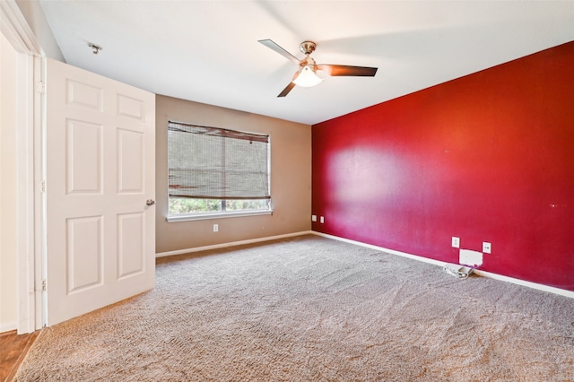 carpeted spare room featuring ceiling fan