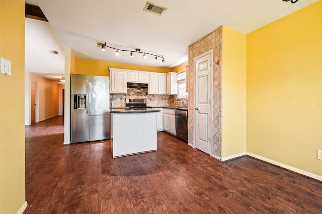 kitchen featuring white cabinets, appliances with stainless steel finishes, and dark hardwood / wood-style floors