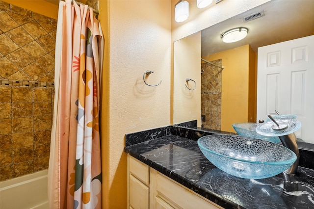 bathroom with shower / bath combo and vanity