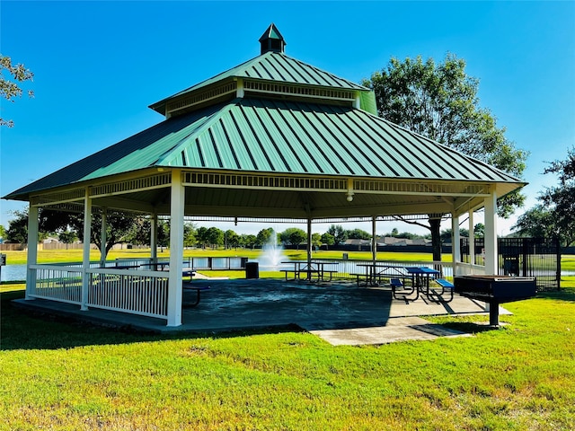 view of property's community featuring a water view, a gazebo, and a yard