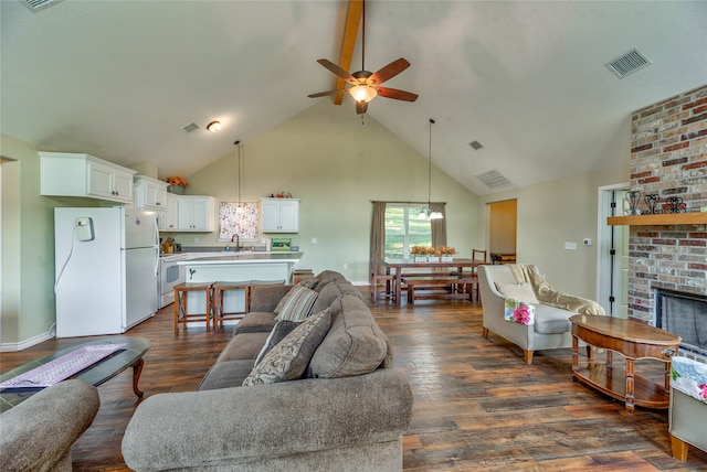 living room featuring high vaulted ceiling, ceiling fan, sink, and dark hardwood / wood-style flooring