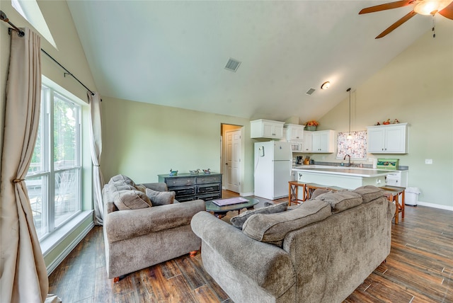 living room with ceiling fan, dark wood-type flooring, sink, and high vaulted ceiling