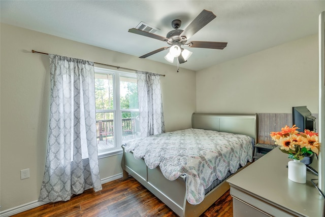 bedroom featuring ceiling fan and dark wood-type flooring