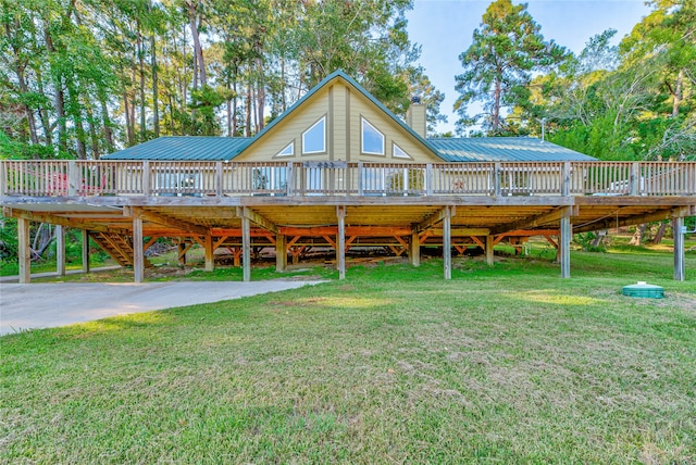 rear view of house with a yard and a wooden deck