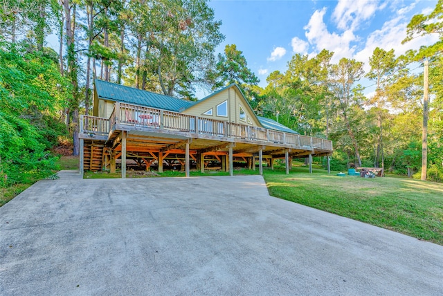 view of front of property featuring a deck, a front lawn, and a carport