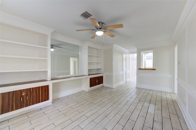 unfurnished living room featuring light hardwood / wood-style floors, built in desk, and ceiling fan