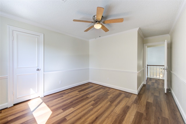 empty room with a textured ceiling, crown molding, dark hardwood / wood-style floors, and ceiling fan