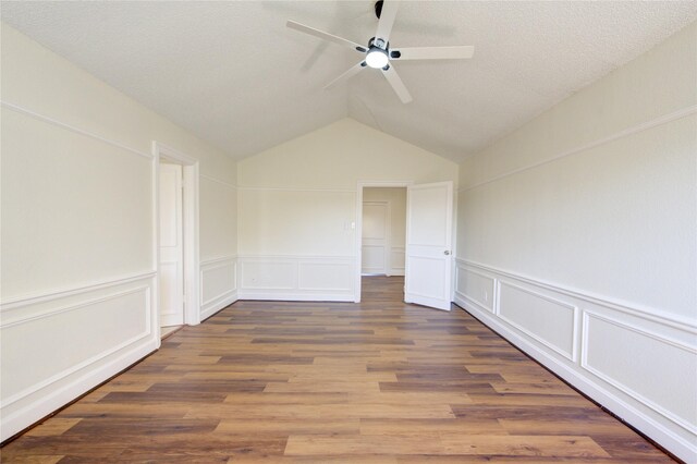 unfurnished room with vaulted ceiling, dark hardwood / wood-style floors, and ceiling fan