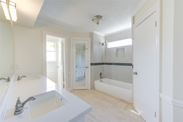 bathroom featuring vanity, crown molding, tiled shower / bath combo, and a textured ceiling