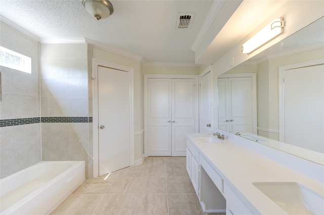 bathroom with vanity, crown molding, a textured ceiling, and a washtub