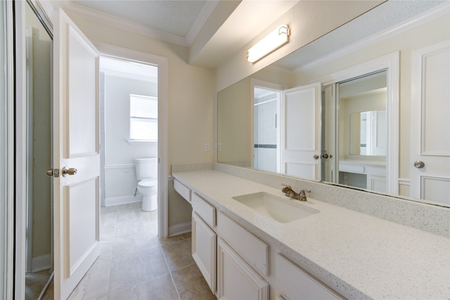 bathroom with vanity, ornamental molding, toilet, and tile patterned floors