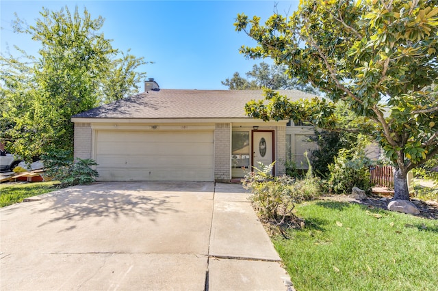 view of front facade featuring a garage and a front lawn