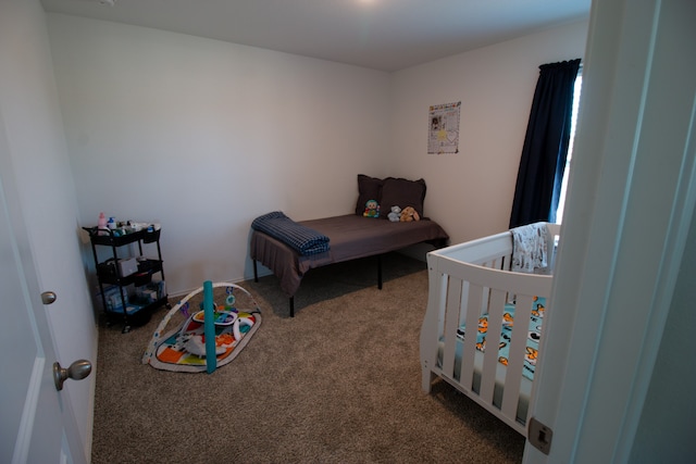 carpeted bedroom with a crib