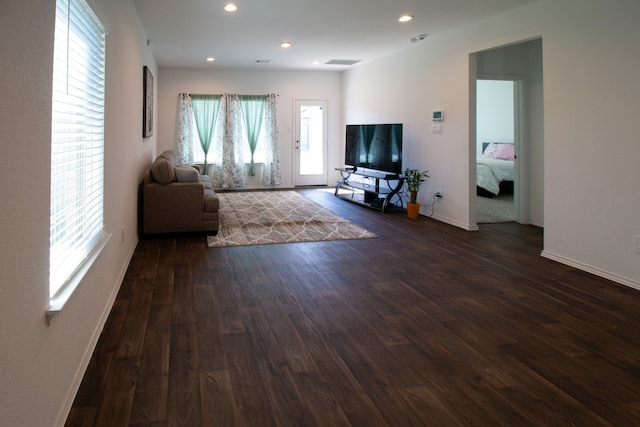 unfurnished living room with dark hardwood / wood-style floors