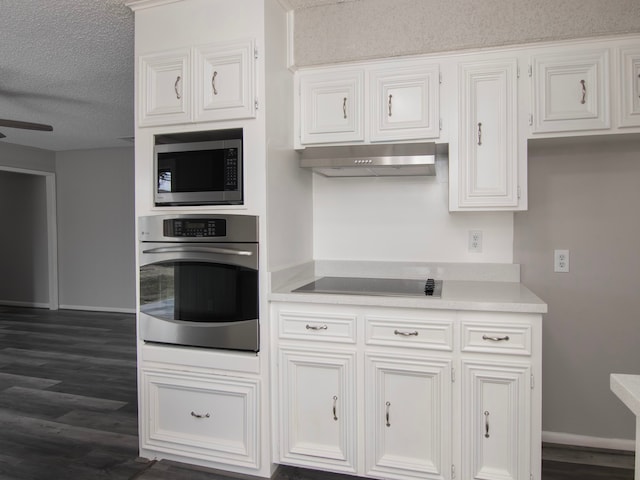 kitchen featuring a textured ceiling, ceiling fan, stainless steel appliances, white cabinets, and dark hardwood / wood-style floors