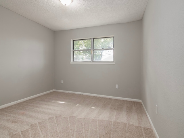 carpeted spare room with a textured ceiling