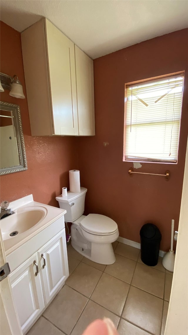 bathroom with tile patterned floors, vanity, and toilet