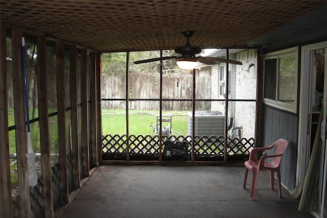 unfurnished sunroom with ceiling fan