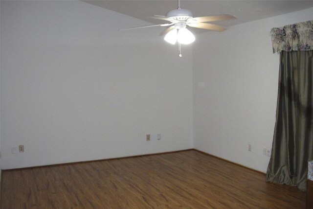 empty room with dark wood-style floors and ceiling fan