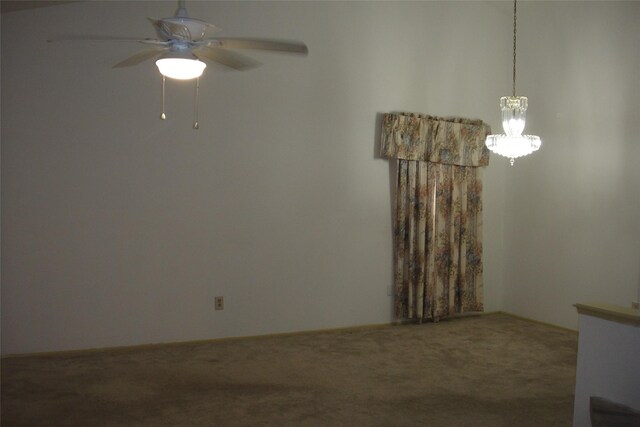 carpeted empty room with ceiling fan with notable chandelier