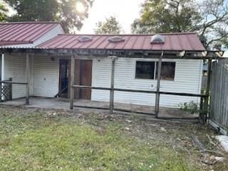 rear view of house featuring a patio area and a yard