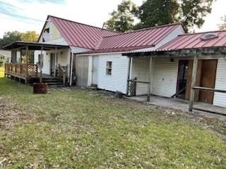 back of house with a yard and a wooden deck