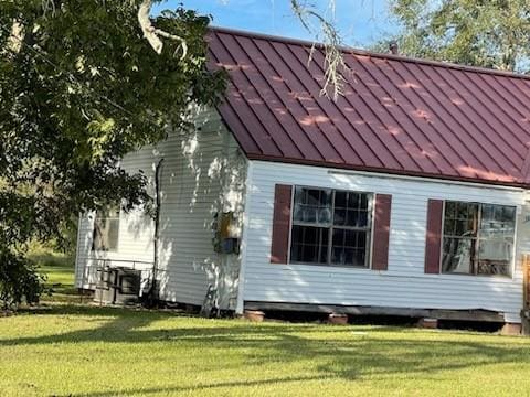 view of property exterior with a lawn