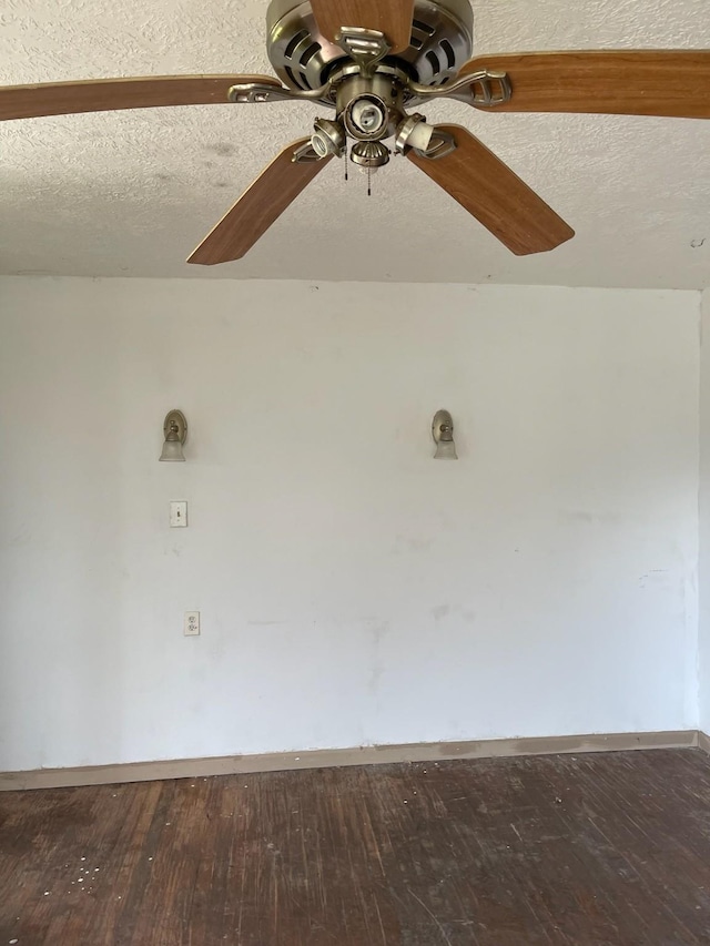 spare room featuring hardwood / wood-style floors and a textured ceiling