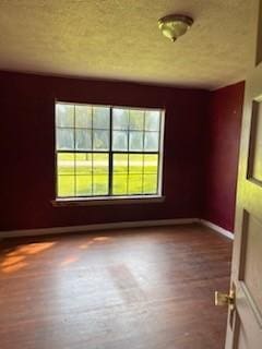 unfurnished room featuring hardwood / wood-style flooring