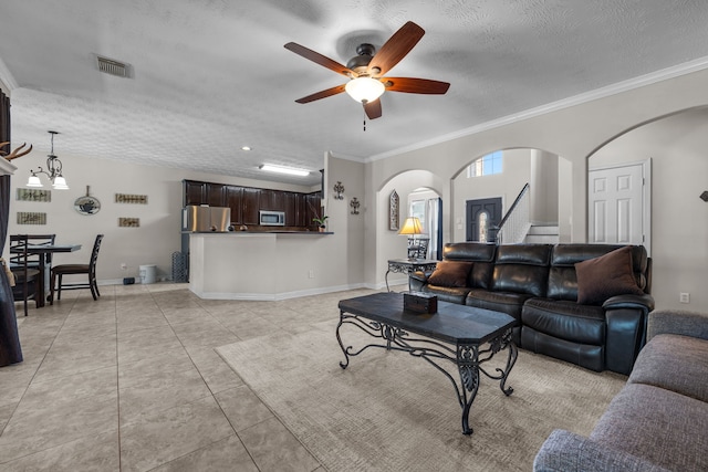 living room with visible vents, arched walkways, ornamental molding, a textured ceiling, and light tile patterned flooring