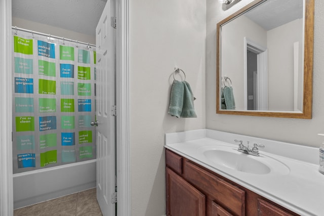 bathroom with shower / bath combo, vanity, a textured ceiling, and tile patterned floors