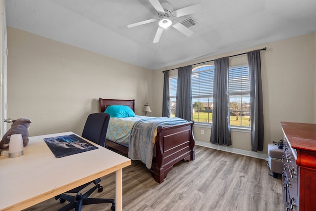 bedroom with visible vents, baseboards, a ceiling fan, vaulted ceiling, and light wood-type flooring