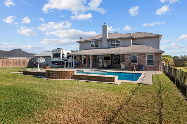 rear view of property featuring a fenced in pool, a patio area, brick siding, and a fenced backyard