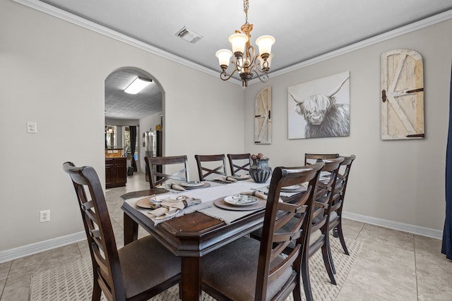 dining area with baseboards, visible vents, arched walkways, and ornamental molding