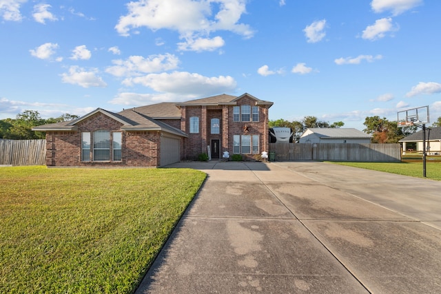 view of front of property featuring concrete driveway, brick siding, a front yard, and fence