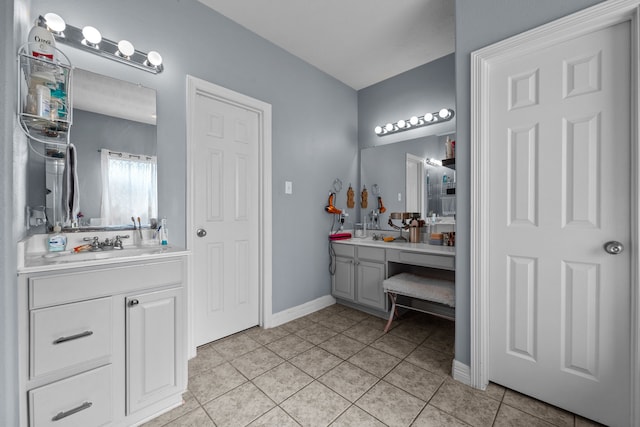 full bath featuring vanity, baseboards, and tile patterned floors