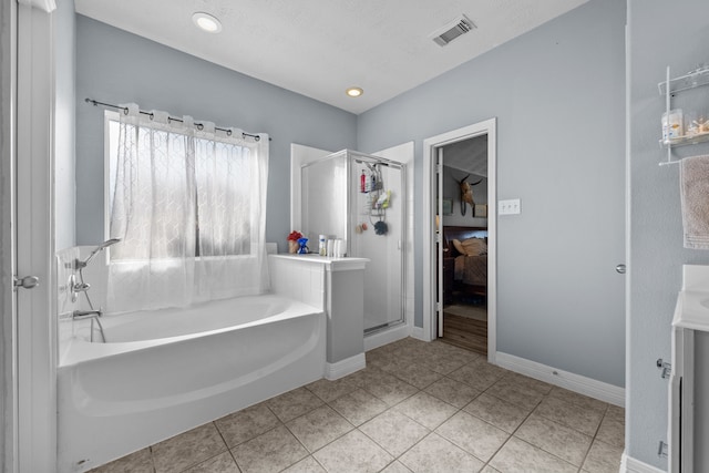 full bathroom with tile patterned flooring, visible vents, baseboards, a bath, and a stall shower