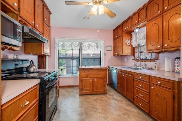 kitchen featuring ceiling fan, stainless steel appliances, and sink